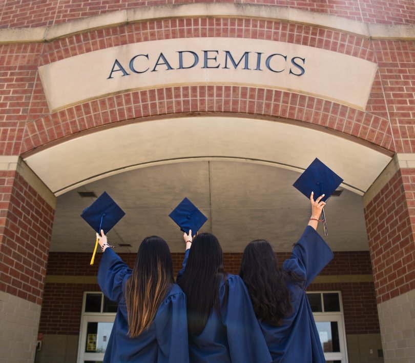 young students facing the door of a university